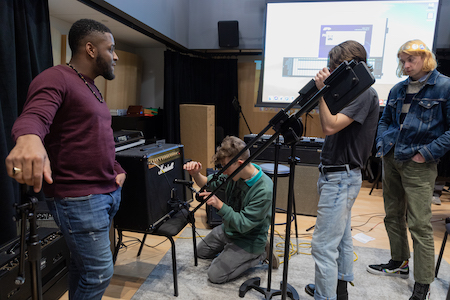 Students learn how to set up mics during Advanced Mic Tech class.