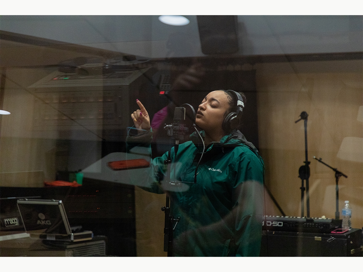 A student records vocals in the Laurie Wagman Recording Studios
