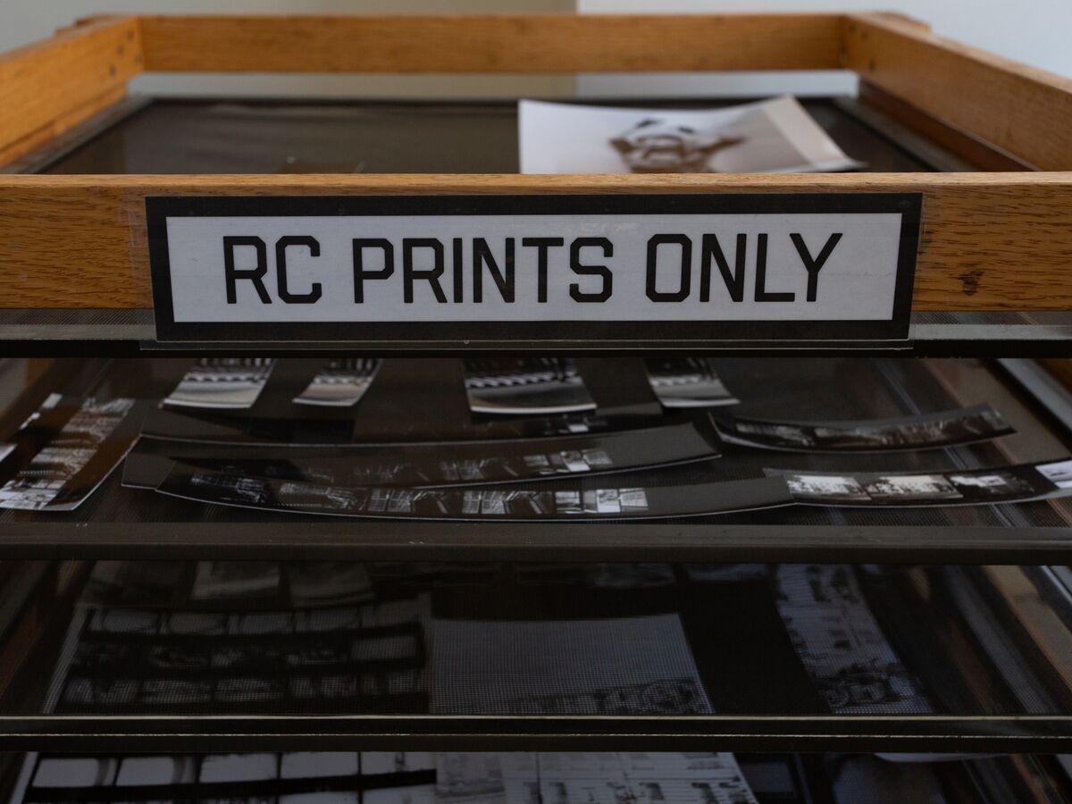 Film and photos are drying in a rack labeled "RC Prints Only"