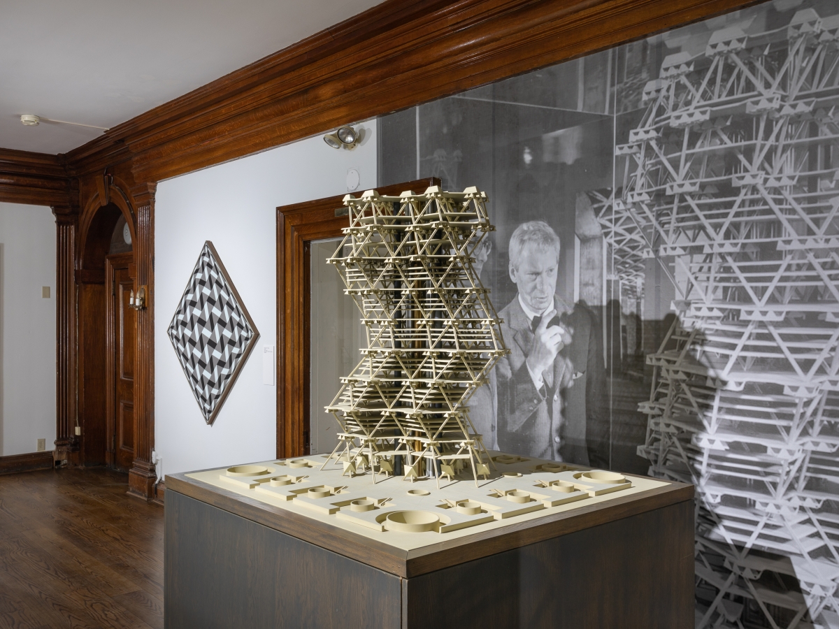 Invisible City Exhibition, 2nd Floor Landing: angled perspective of the landing, with the model of Anne Tyng's and Louis Kahn's City tower in the right foreground and a geometric painting in the left background