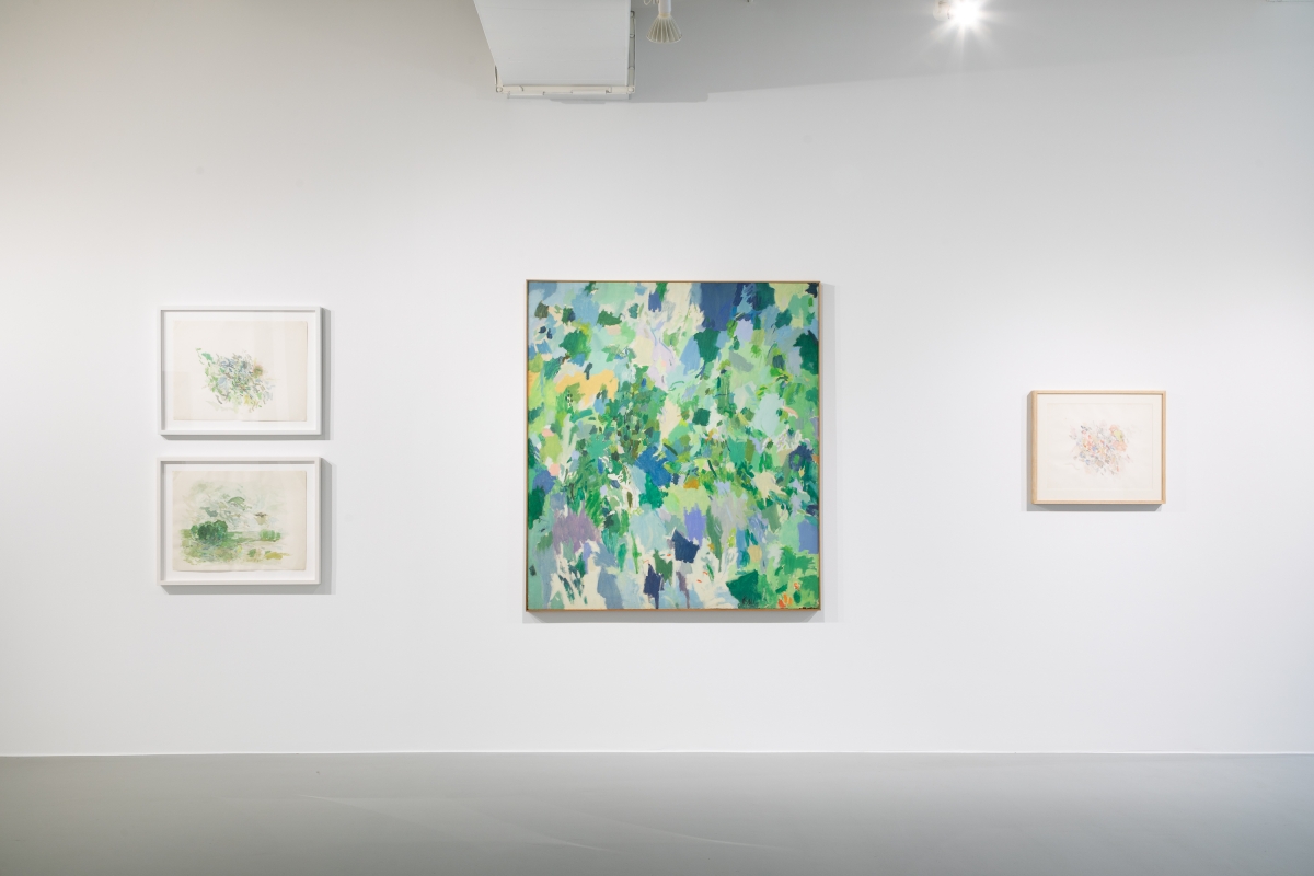 an installation shot of Larry Day's work in a gallery space. Two landscape oriented, framed abstract works hand on the left, a larger all-over abstract painting hangs in the center and another smaller framed work hangs on the right.