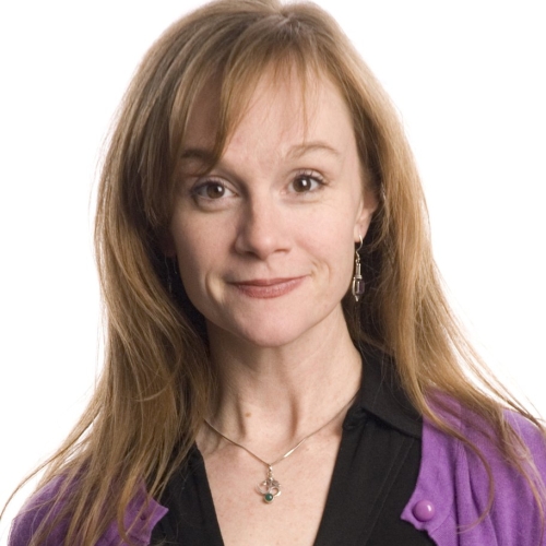 Head shot image of Jennifer Childs with red hair in black shirt and purple jacket