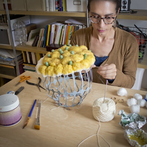 Joy Dilworth creating yellow and green fibers piece at table