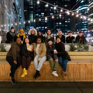 Students pose for a picture during an ice skating night at Dilworth Park