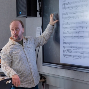 Faculty member Randy Kapralick shows an excerpt to students during class.
