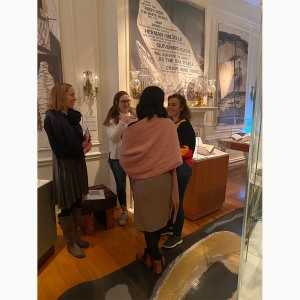 Students explore an exhibit at The Rosenbach with a tour guide.