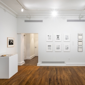 Invisible City Exhibition, Gallery C: group of 6 photographs on far wall next to a column of three photographs; a single photograph is on side wall above a display on a pedestal