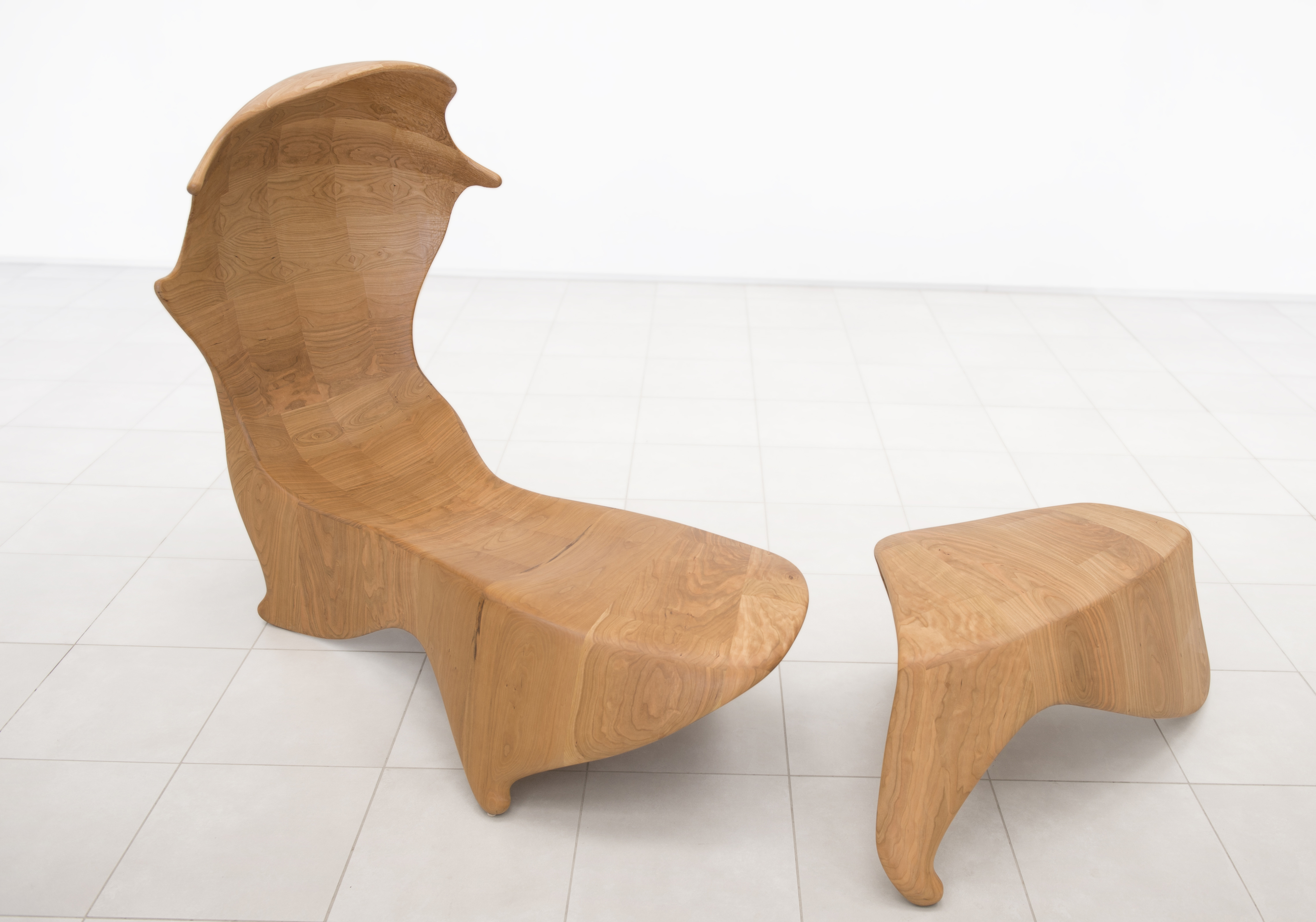 An abstract recliner and ottoman in light wood by Keunho Peter Park