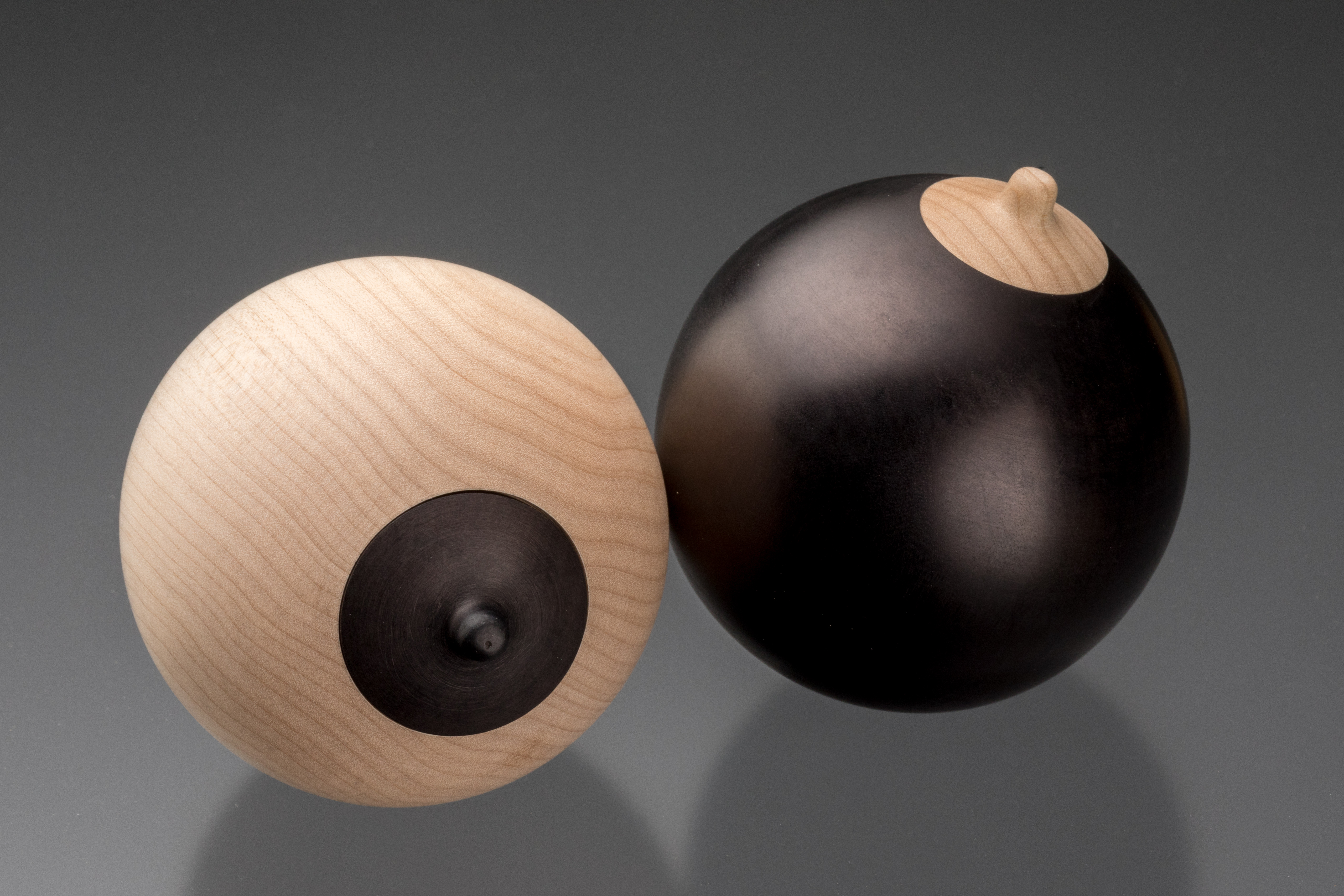 Two balls in black and tan with lids 