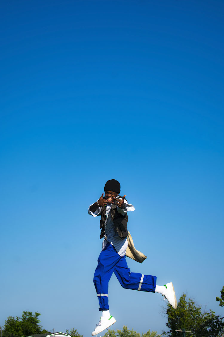 A man jumps in the air and strikes a pose. "Drew Bonner Shoot" by Justin C. Henry '23