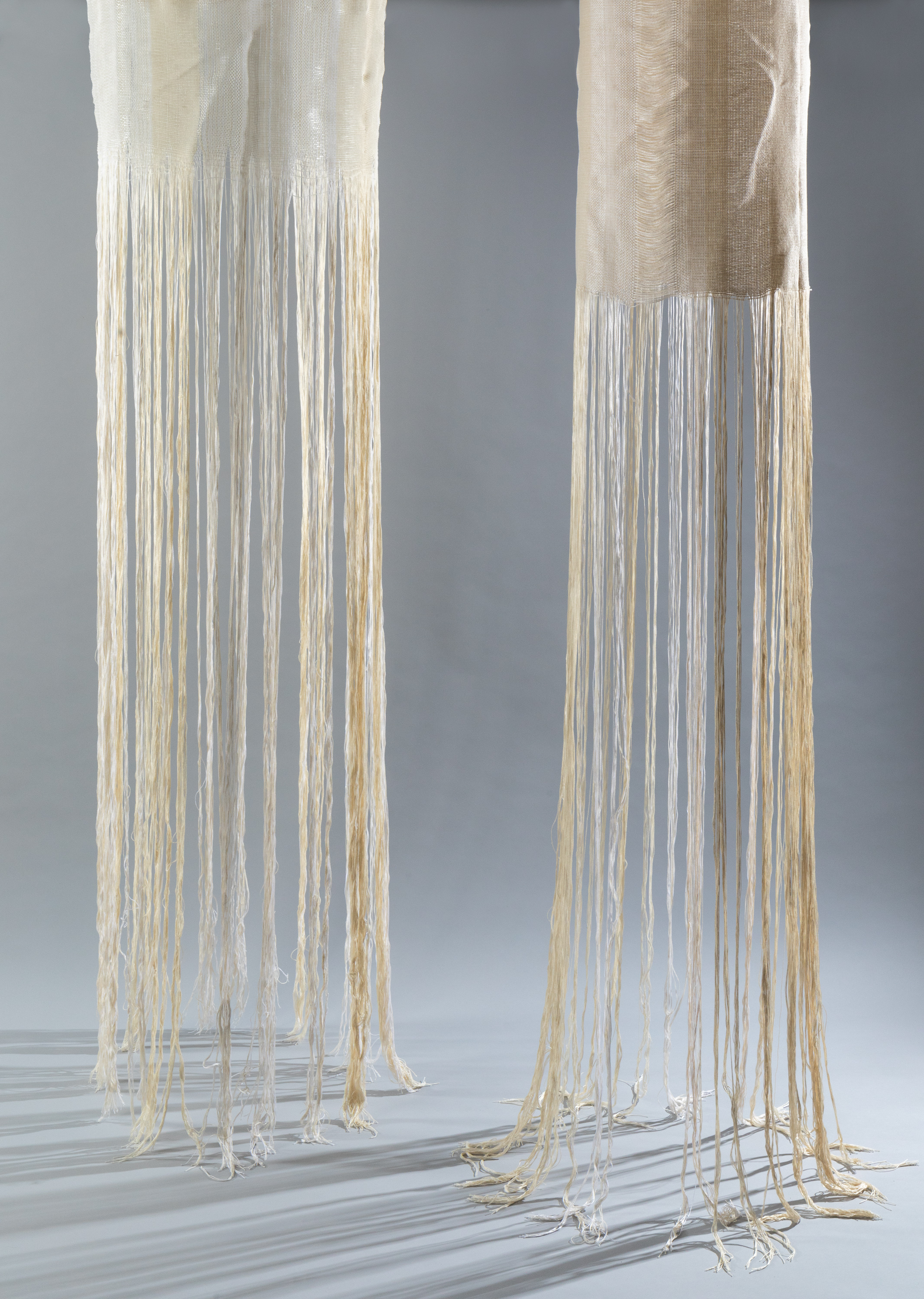 Two textiles hanging by Elizabeth Reed