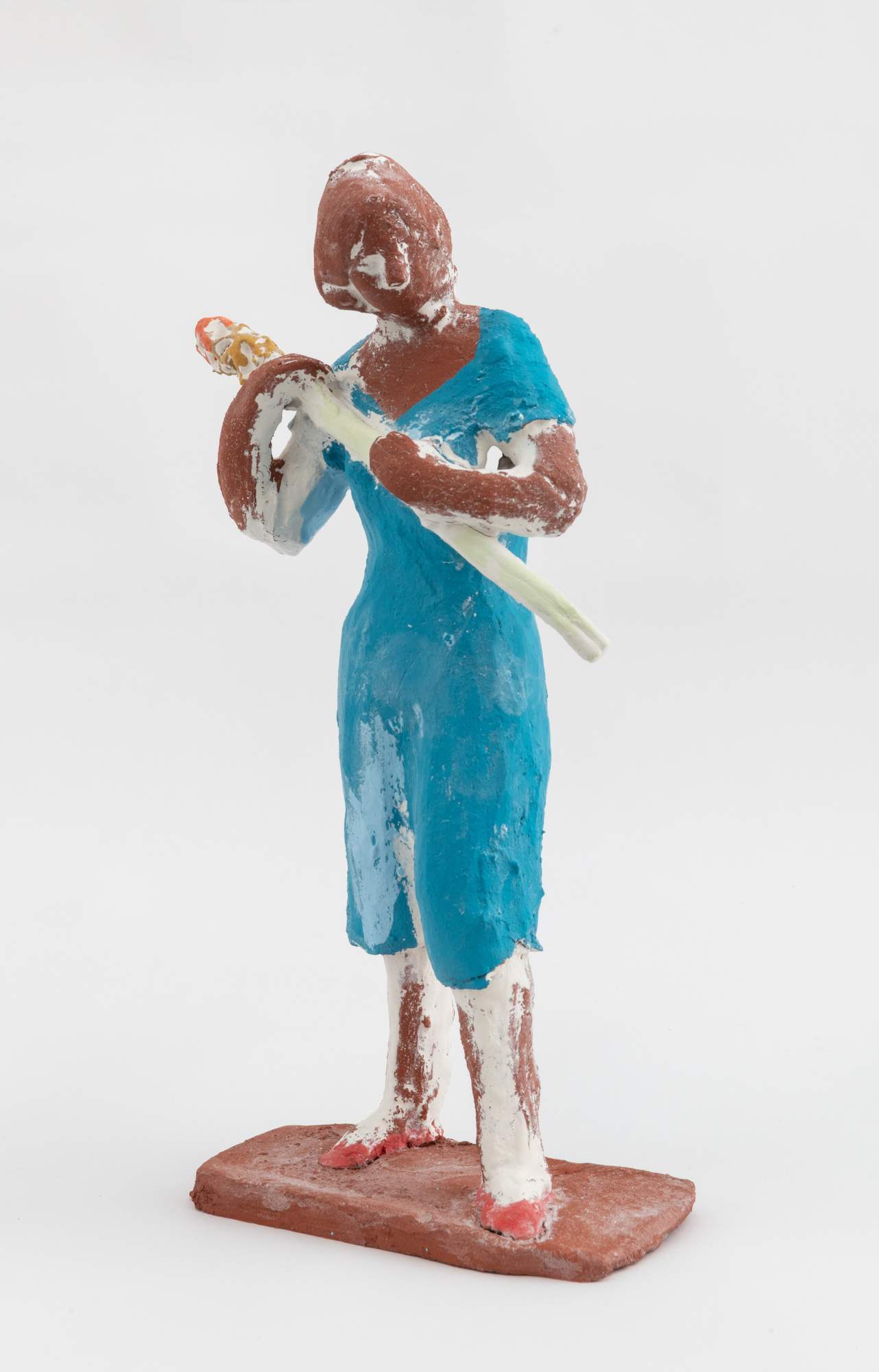 Small sculptural figure holding object 