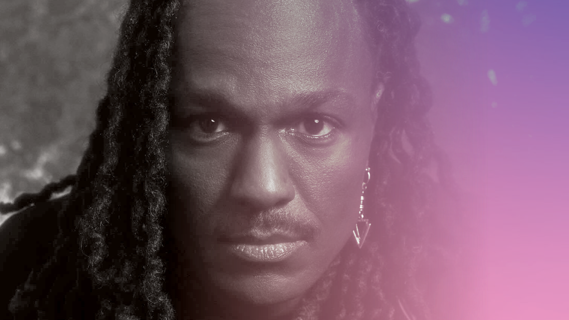 a black and white portrait of Jeffrey L. Page overlaid with a lavender gradient at the right. Page has a serious look and a light mustache and a pointed arrow-like earring. page has dark skin and big eyes, with curling long dreads falling to his shoulders