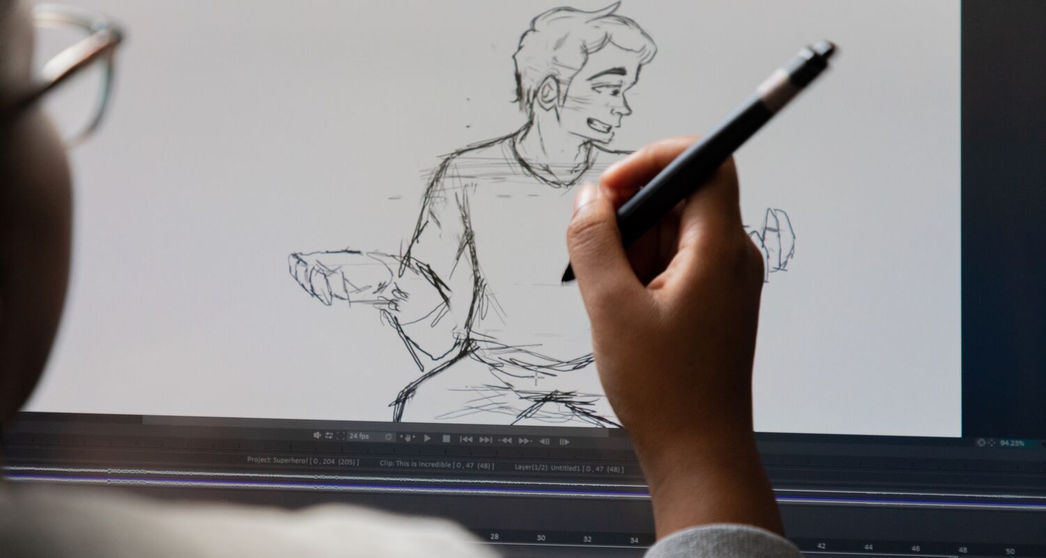A student uses a tablet to draw a male figure