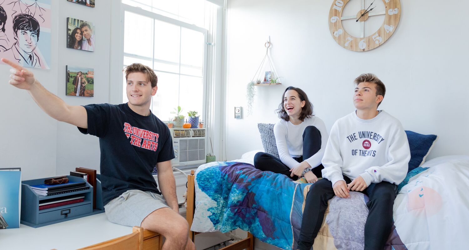 Three students hang out in Spruce Residence hall.