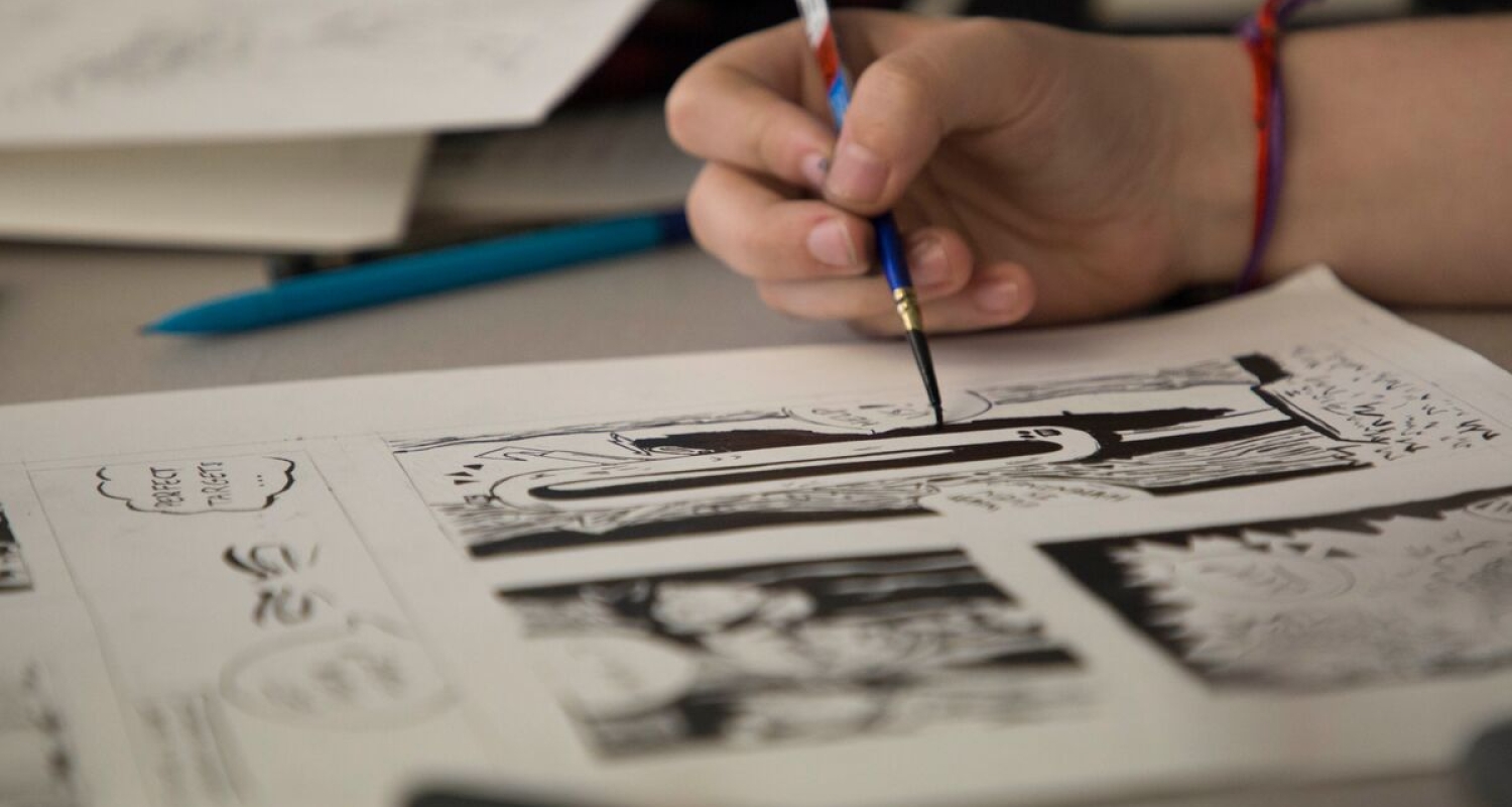 A student illustrates a comic