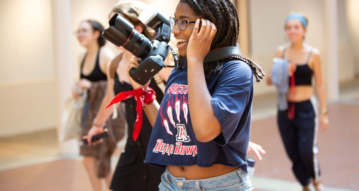 UArts students smile taking photos on set with high-tech camera