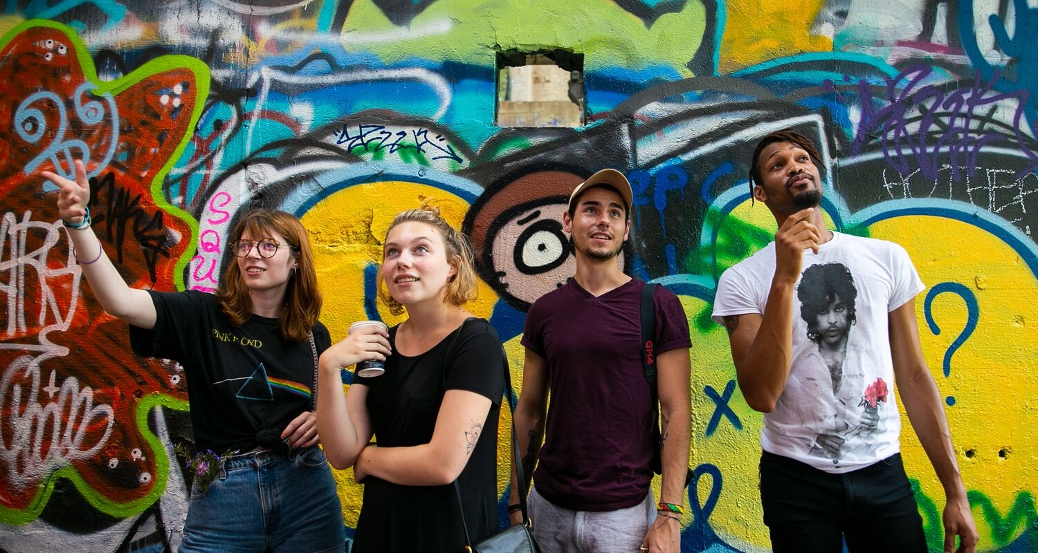 UArts students tour and smile in front of Philadelphia's Graffiti Pier
