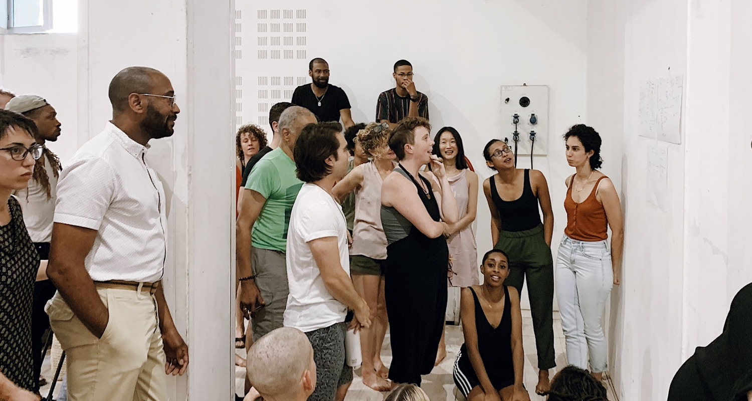 Dance students perform in a unique space with white walls and close audience members