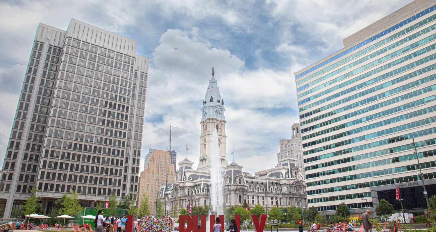 A wide shot of Love Park with a large sculpture that says I heart Philly