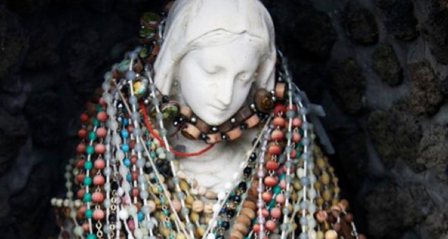A statue of The Madonna with many mutli-colored rosary beads around her neck. The bottom of the image reads “Marisol By José Rivera Directed by Cat Ramirez”, and “Arts Bank Main Stage Feb. 23–24, 28–Mar. 2 at 7:30 p.m. / Feb. 24–25, Mar. 2–3 at 2 p.m.”. The bottom reads For tickets and showtimes, visit universityofthearts.ticketleap.com or call 215-717-6310.” 