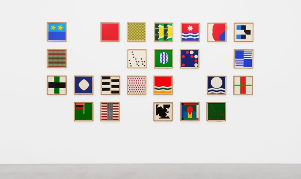 Image of Kambalu's seres of multicolored square framed and arranged on a white wall