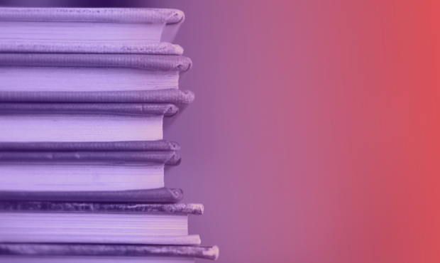 a stack of books with a purple and pink background