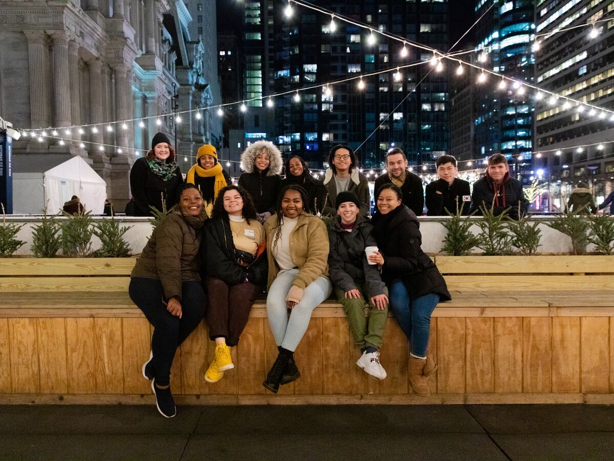 Students pose for a picture during an ice skating night at Dilworth Park