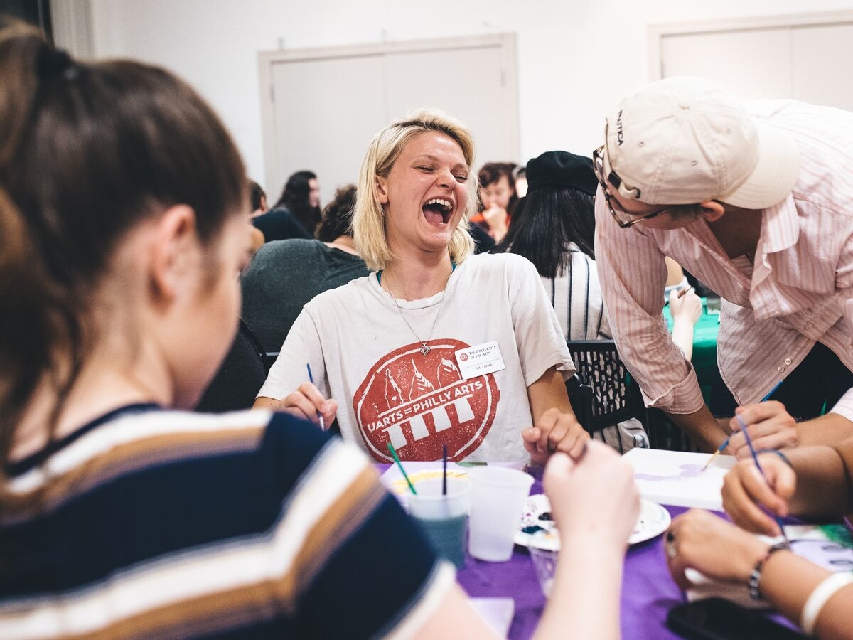 A pair of students laugh during Paint Night