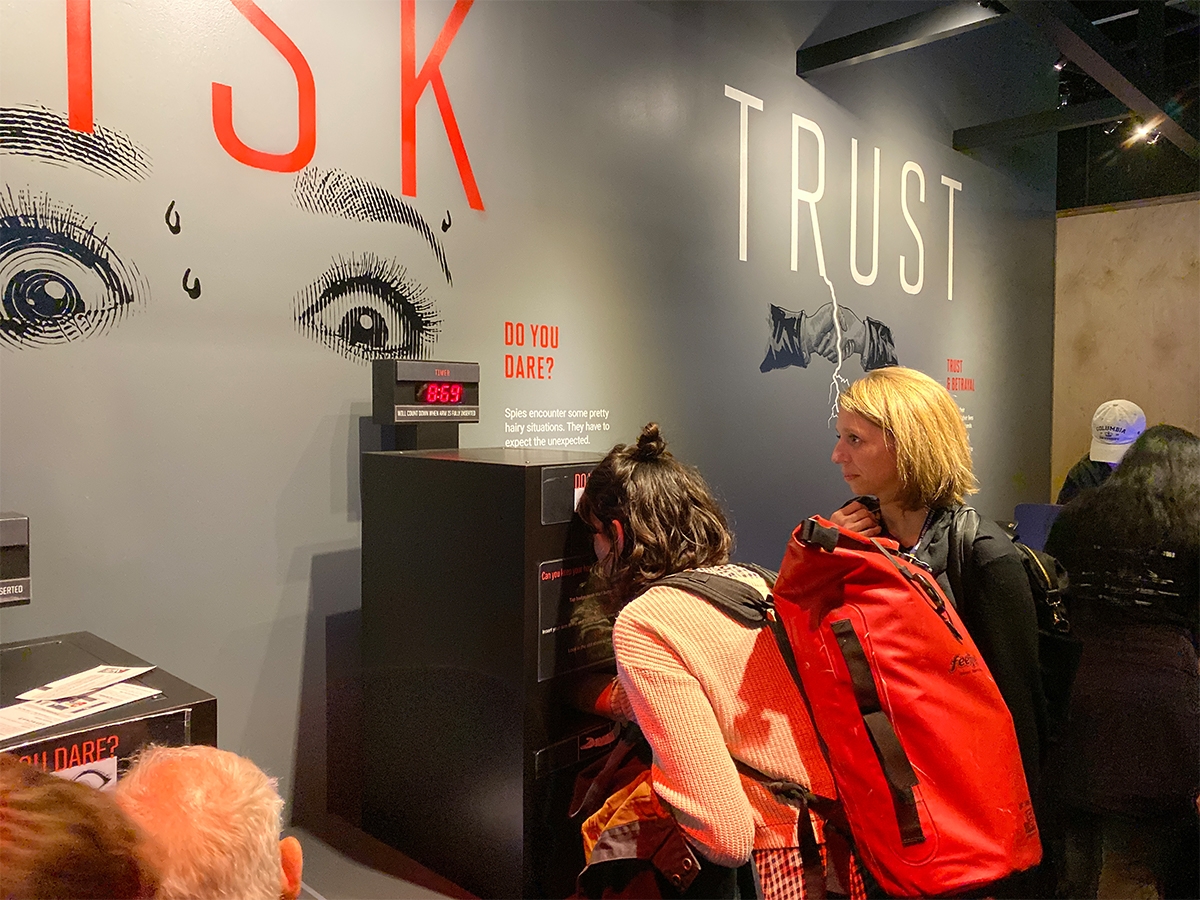 Faculty member Stephanie Reyer and a student look at an interactive exhibit at the International Spy Museum.