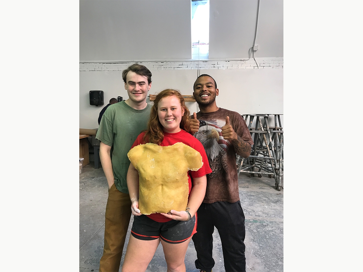 Students pose with a torso