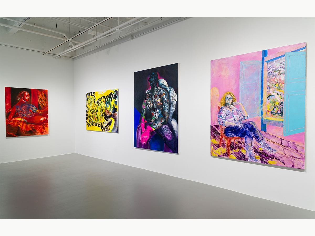 A set of four paintings hanging on a wall in a gallery.