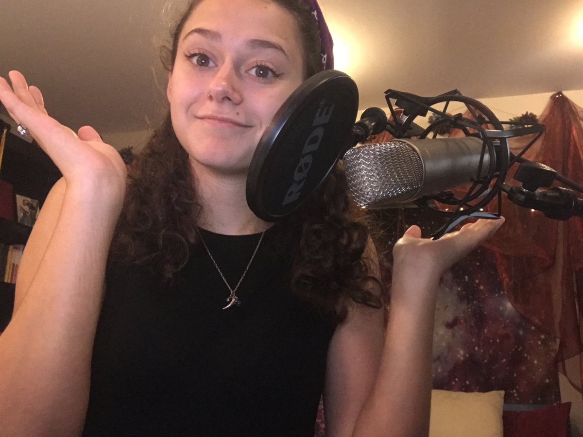Selfie of Isabella in front of a studio microphone