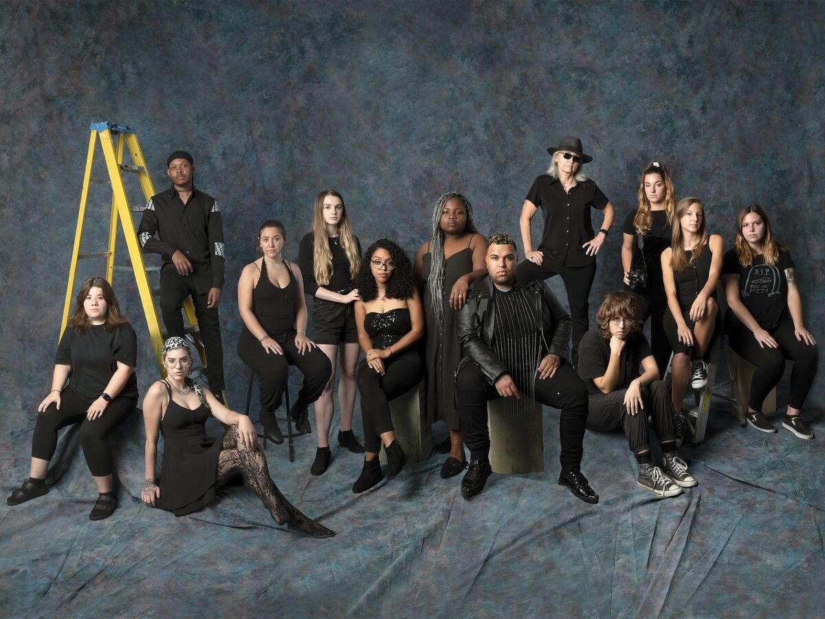The fashion editorial class poses in front of a backdrop.