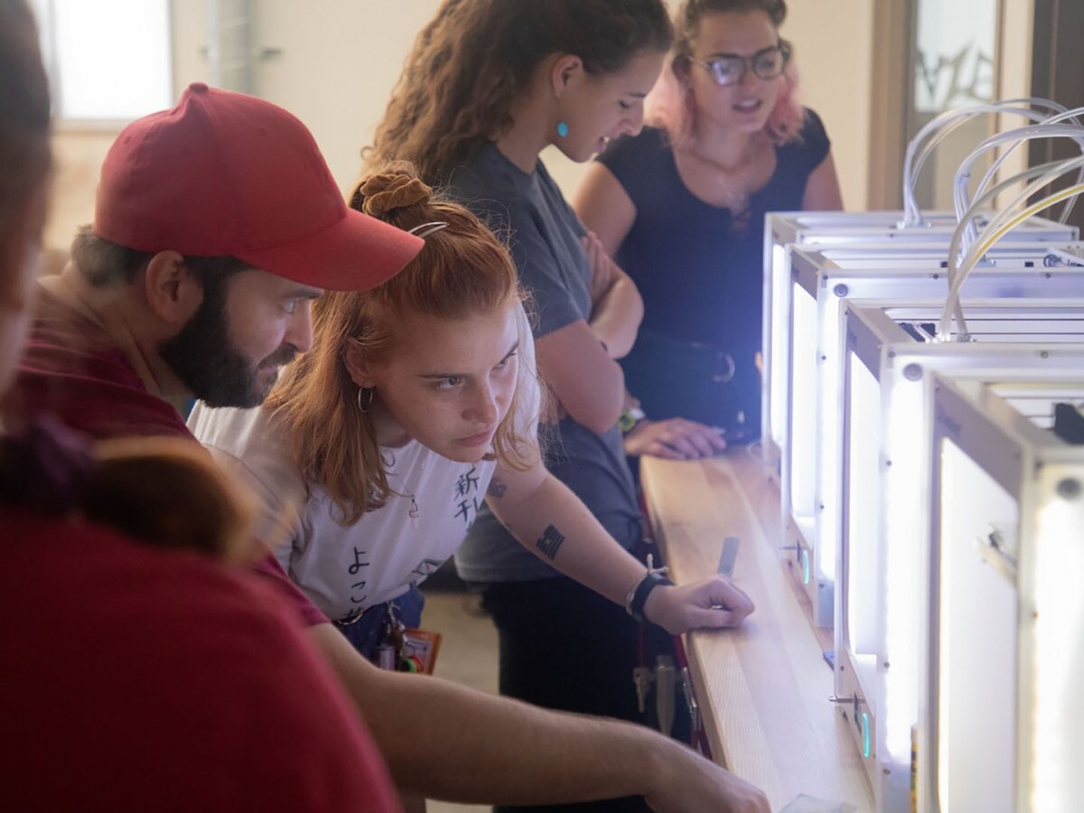 Students look inside a 3D printer