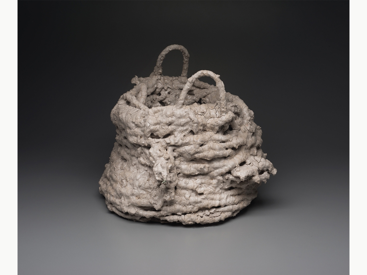 A sculpture of a basket made of rope, clay slip and milk