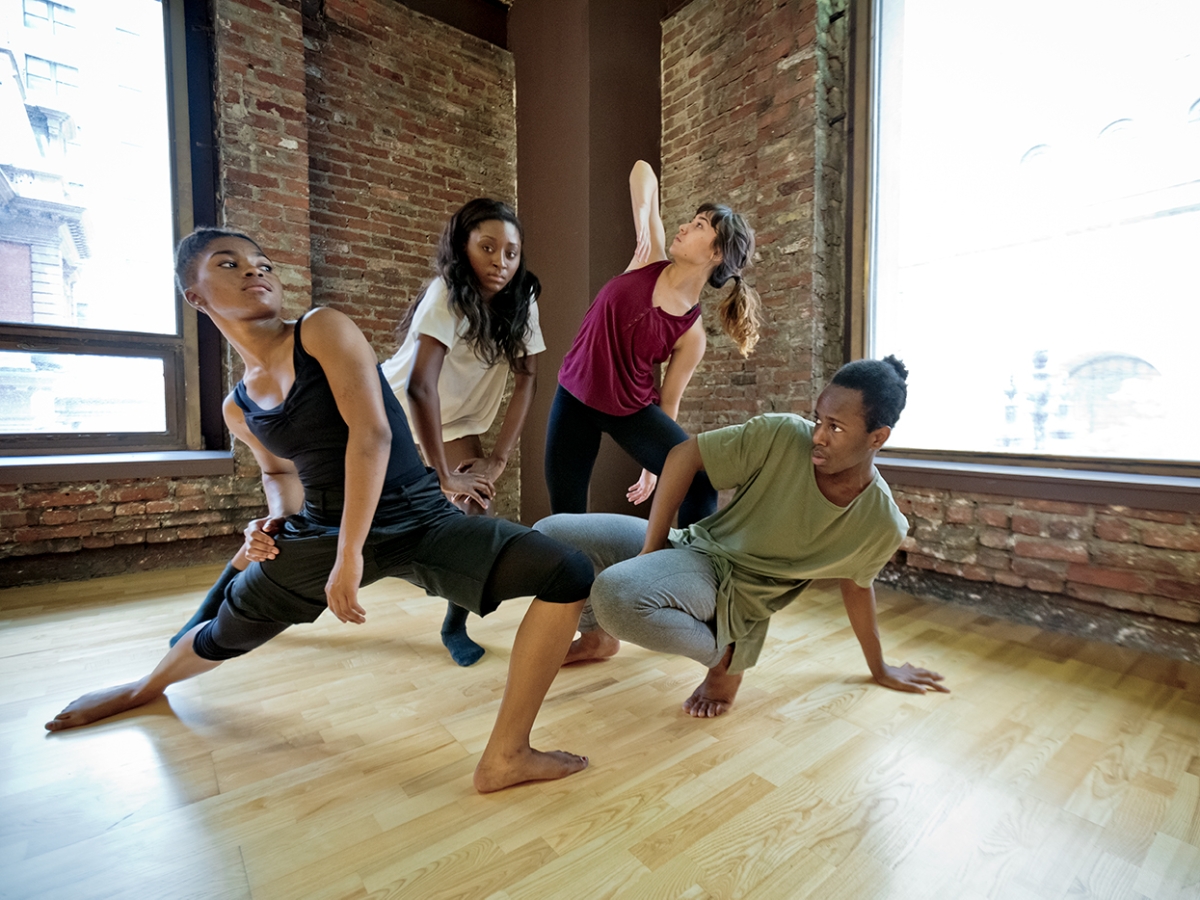 Four dancers work on their choreography in the studio