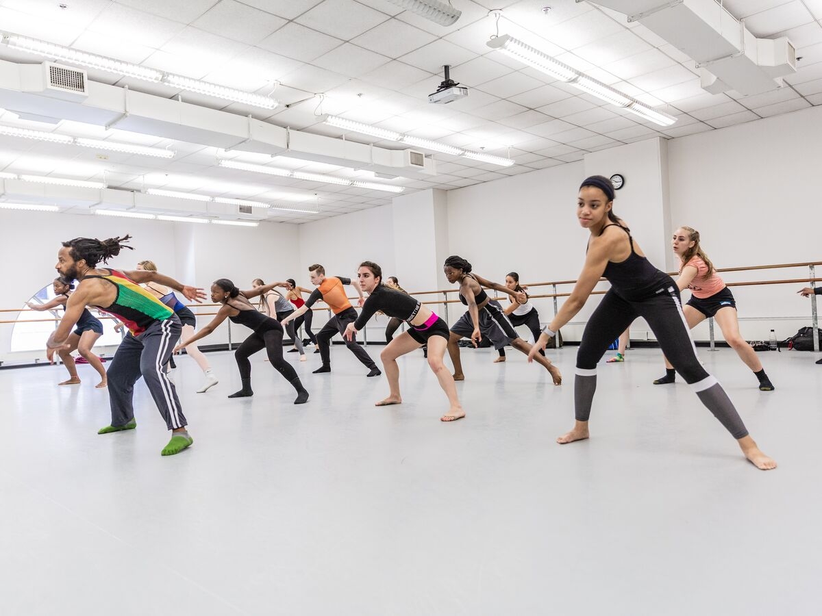 A dance instructor leads a dance class in the studio