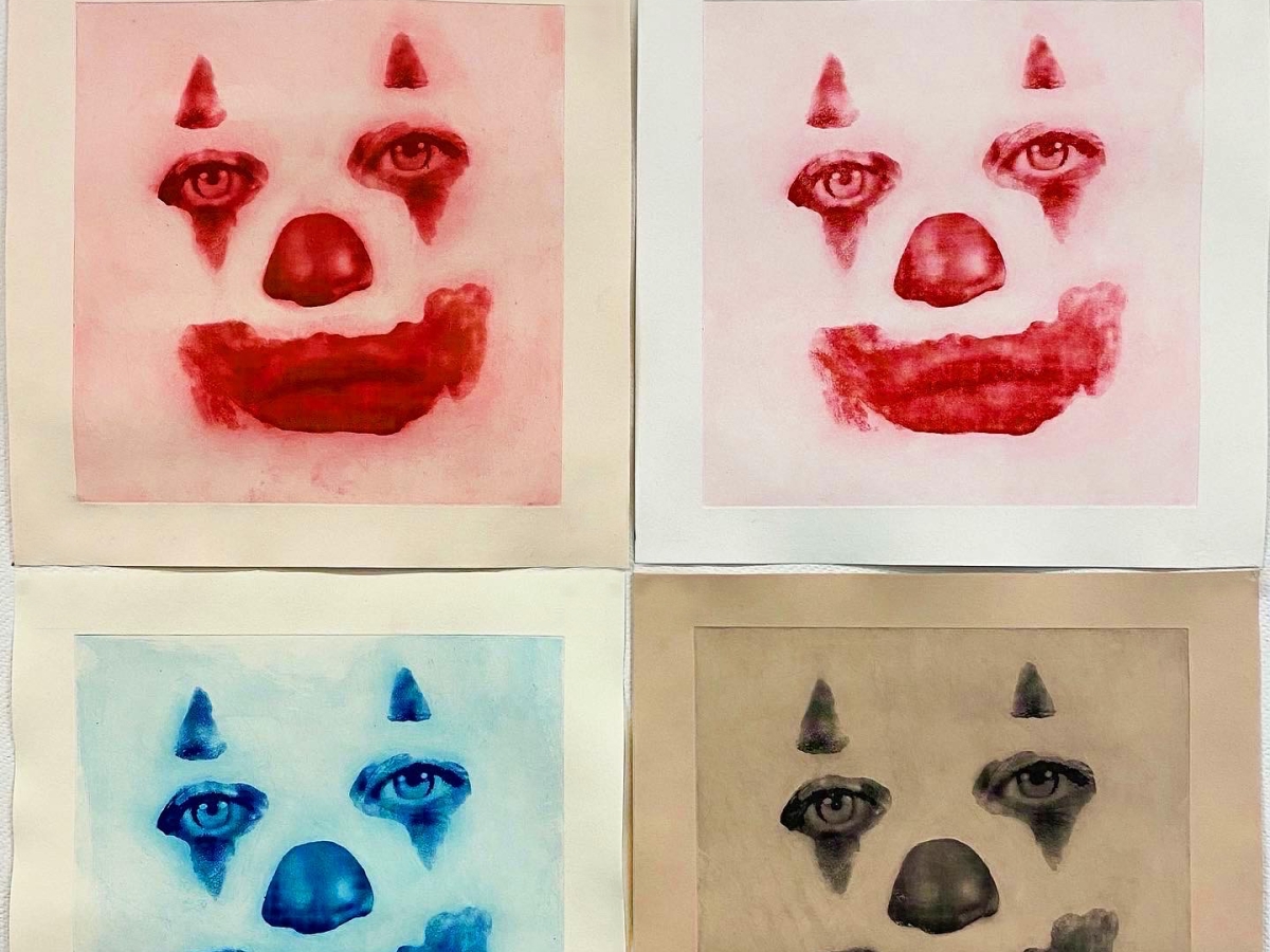 print artwork featuring four identical clown faces printed in different colors on different square sheets of paper arranged 2x2