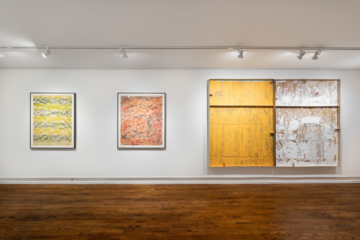 four multicolored works hang horizontally on a white wall