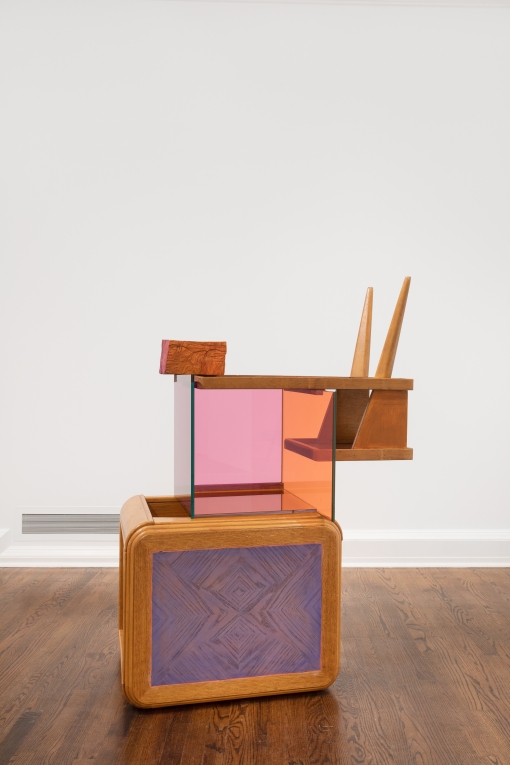 Installation view of floor sculpture composed of two different side tables and a glass multicolored box