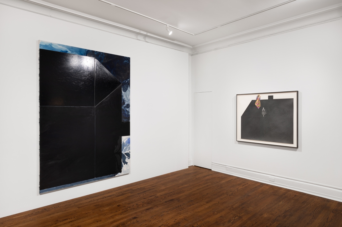Installation view of two artist works on adding walls: a large black house on its side to the left; to the right a graphite shaded house with a figure at the top
