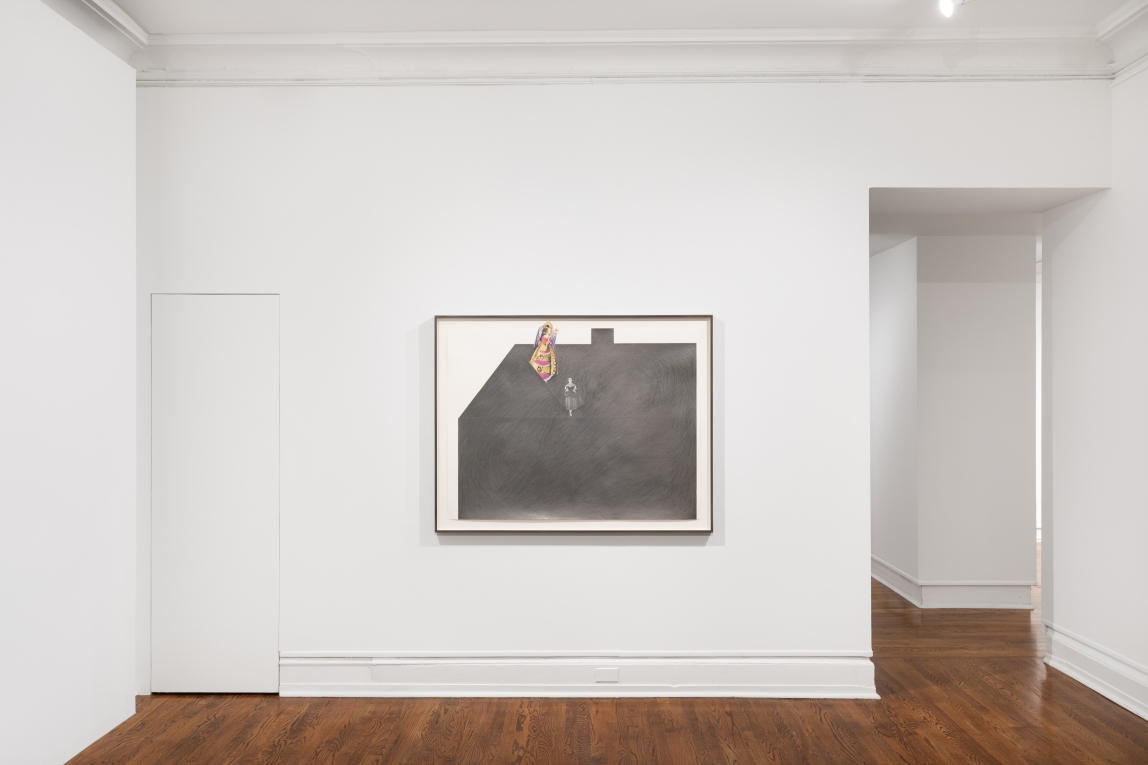 Installation view of collage of an all black house in graphite with a figure near the top of the house