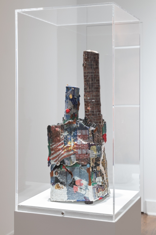 Installation view of collaged ceramic sculpture with two tower-like attachments