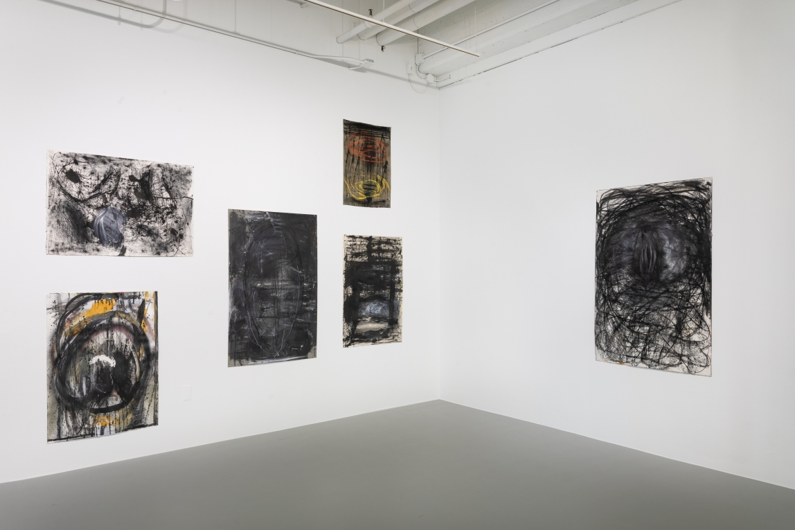 Installation view of adjoining walls with five drawings to the left and one to the right