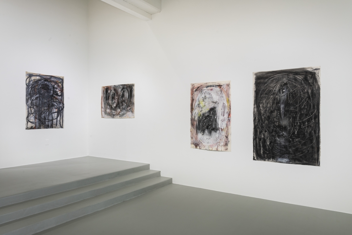 Installation view of four paintings across two adjoining walls