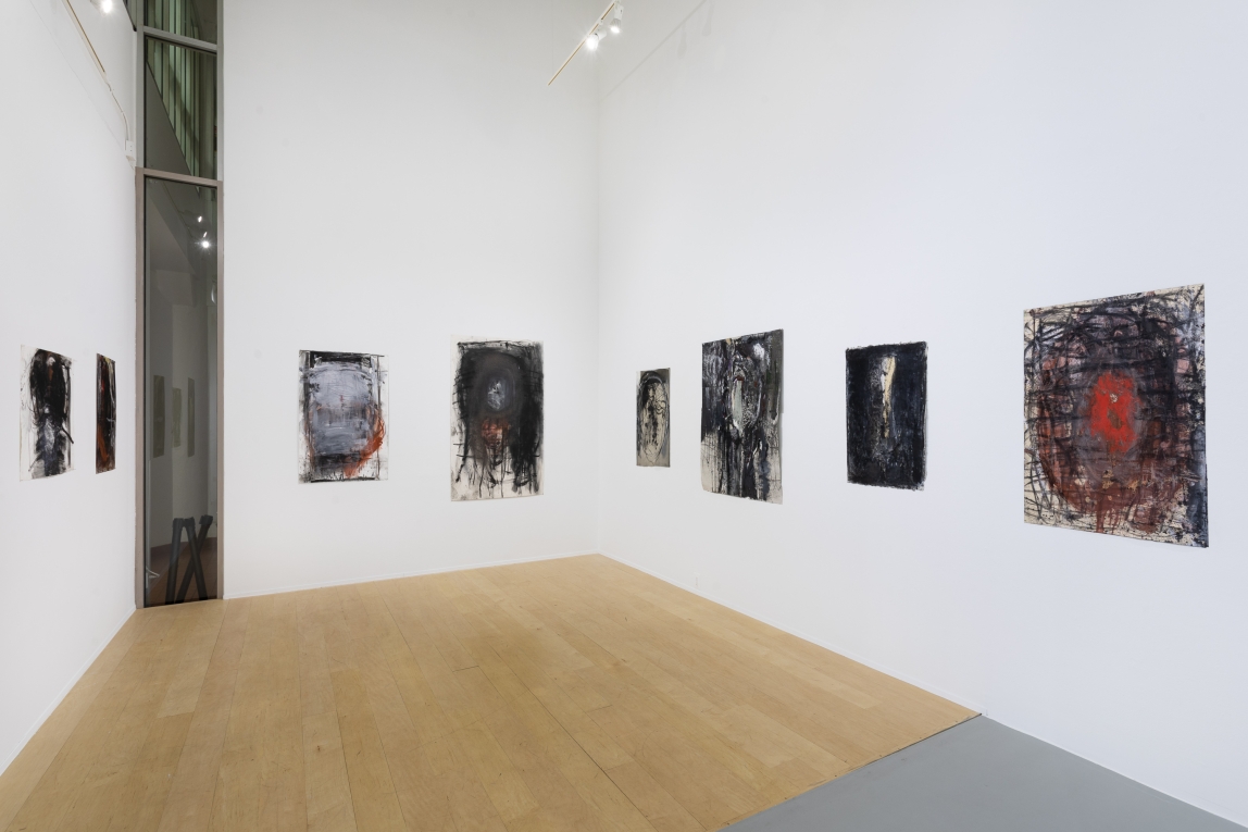 Installation view of a series of drawings across three walls