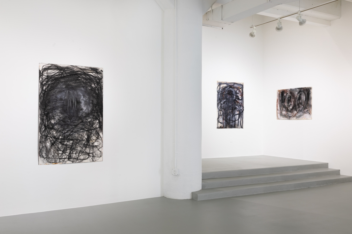 Installation view of gallery with one drawing in left foreground and two in background