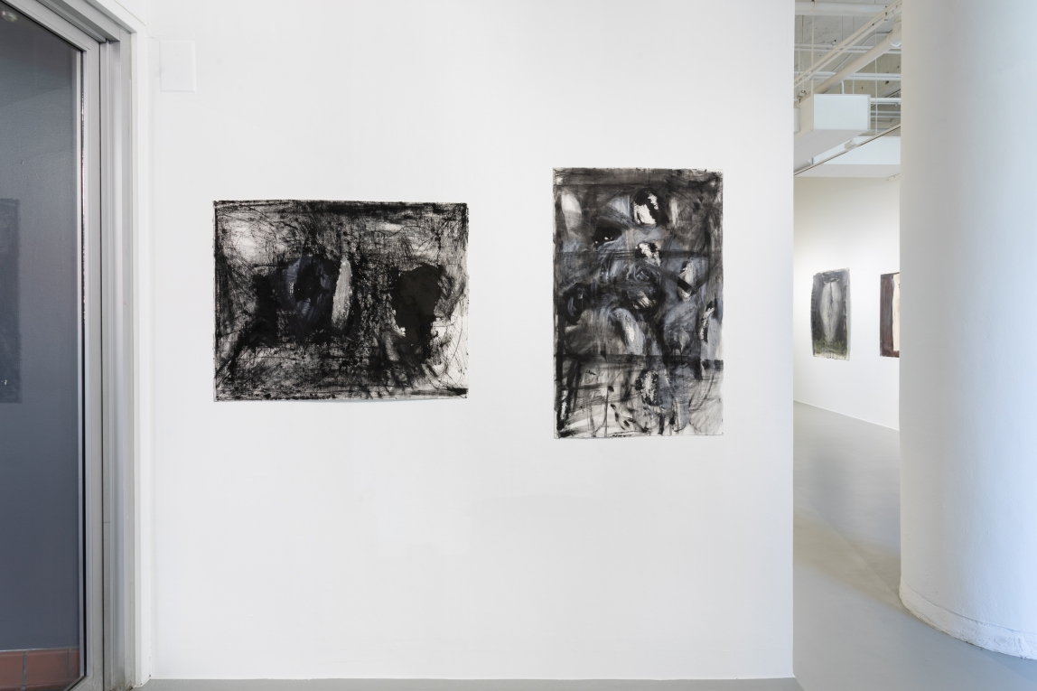 Installation view of two drawings on wall in foreground