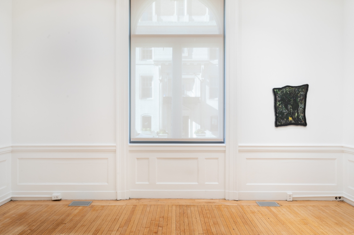 Installation view of framed painting next to window